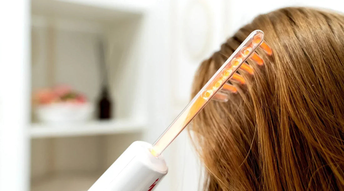 Woman using a high frequency wand for scalp and hair growth