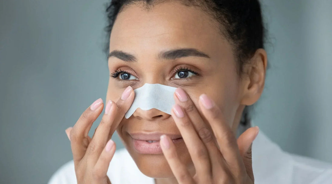 Woman removing nose blackheads at home